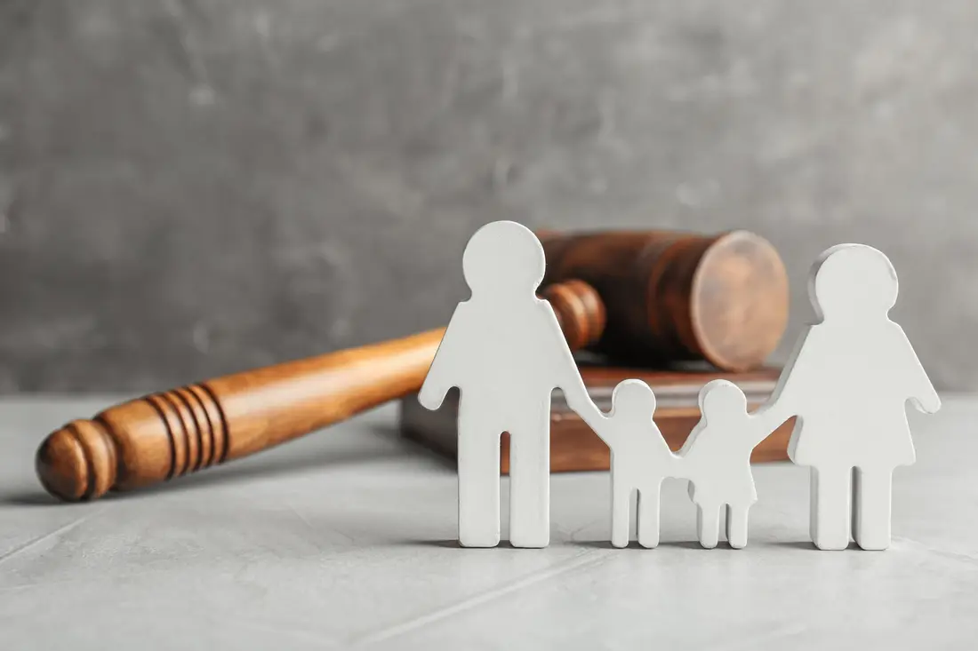 White family figures in front of a gavel