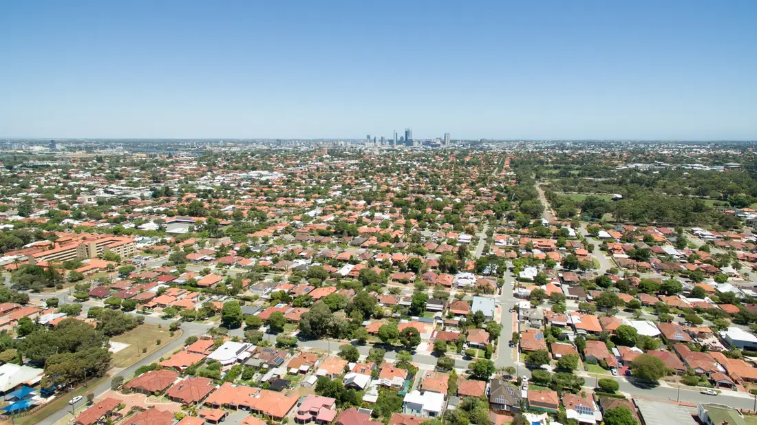Aerial view of Perth suburbs with the city skyline behind