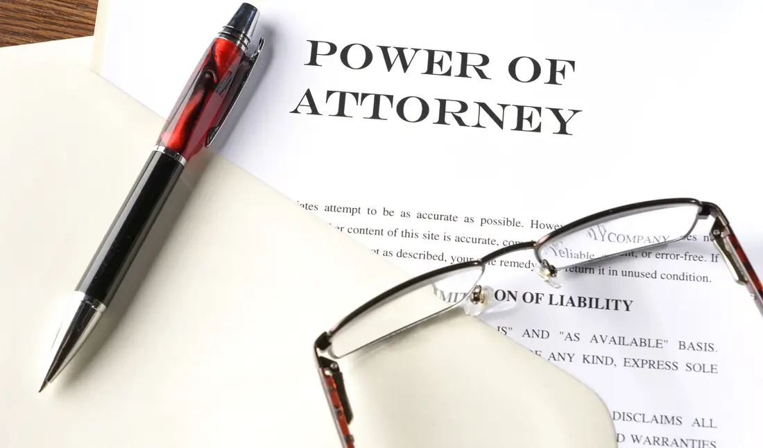 Power of attorney document with a pen and glasses